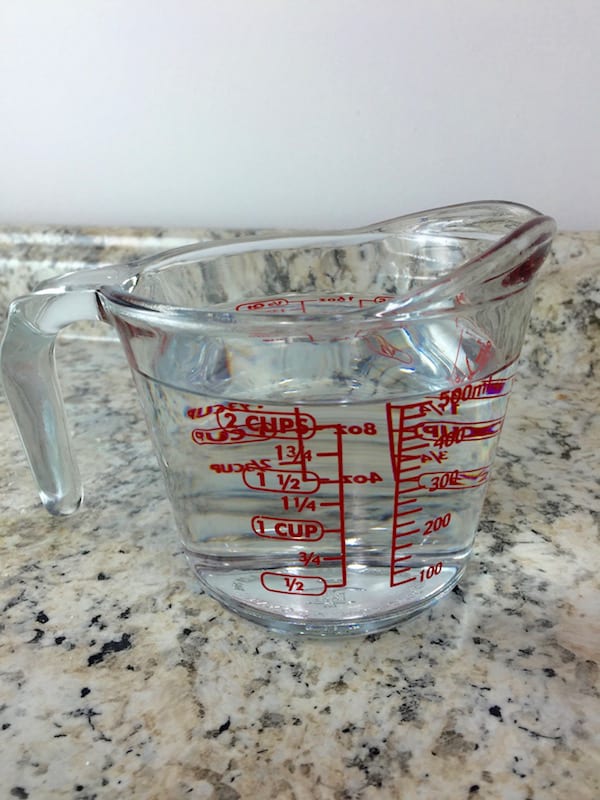 Measure cup with two cups of water.