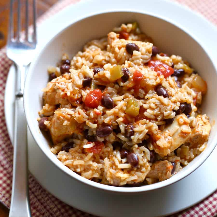 Chicken, rice, and black bean burrito bowl in white bowl.