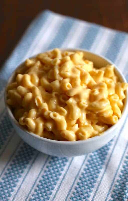 Creamy macaroni and cheese in a white bowl.