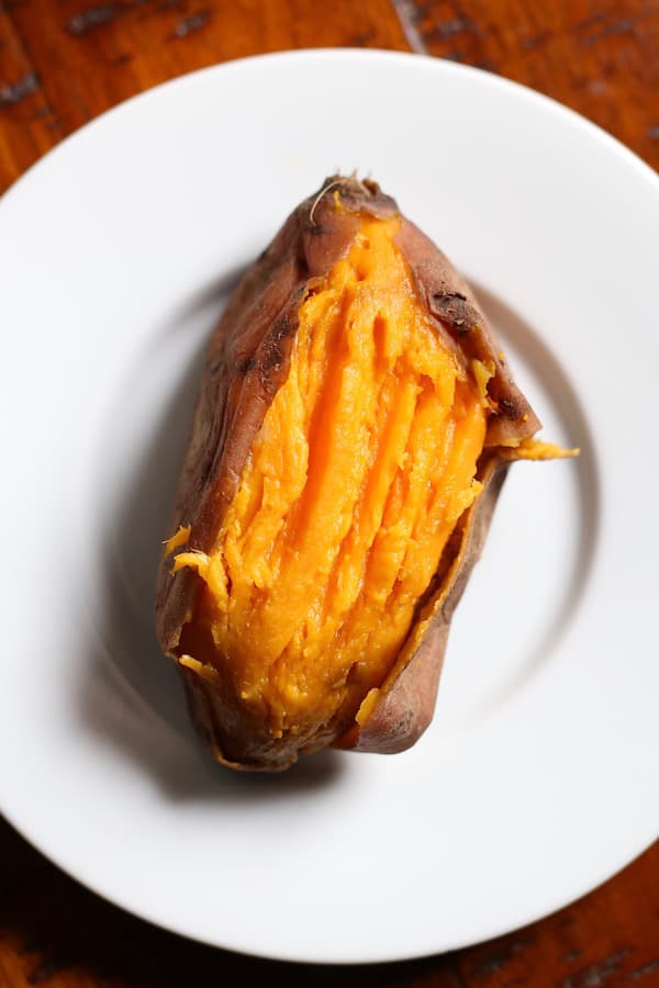 Cooked sweet potato on white plate.