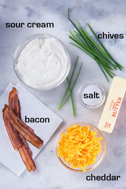 Toppings for mashed potatoes. Sour cream. Chives. Salt. Butter. Cheddar. Bacon.