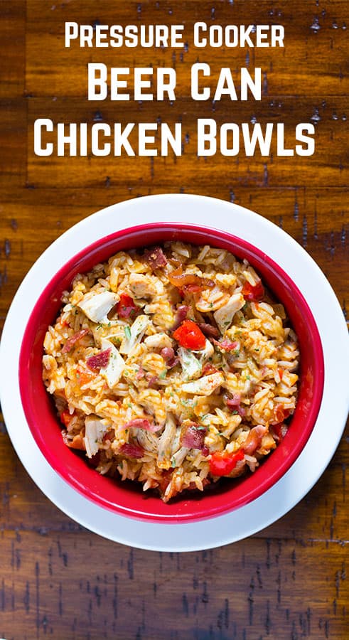 Beer can chicken in red bowl. The rice dish is topped with chopped chicken, bacon, and red bell peppers.