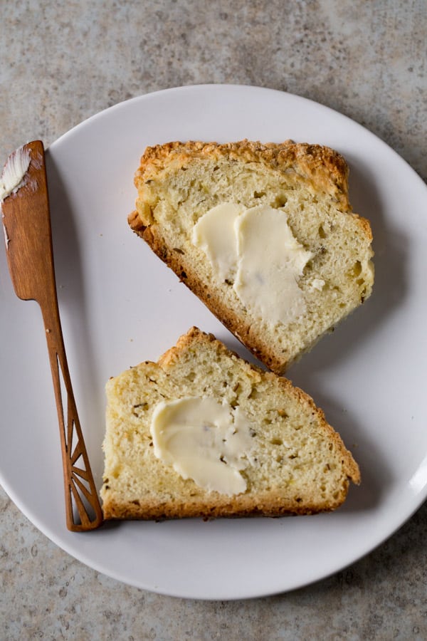 Irish soda bread slices spread with butter on on a plate. 