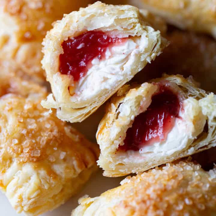 Cranberry cream cheese hand pie split in half to show the filling.