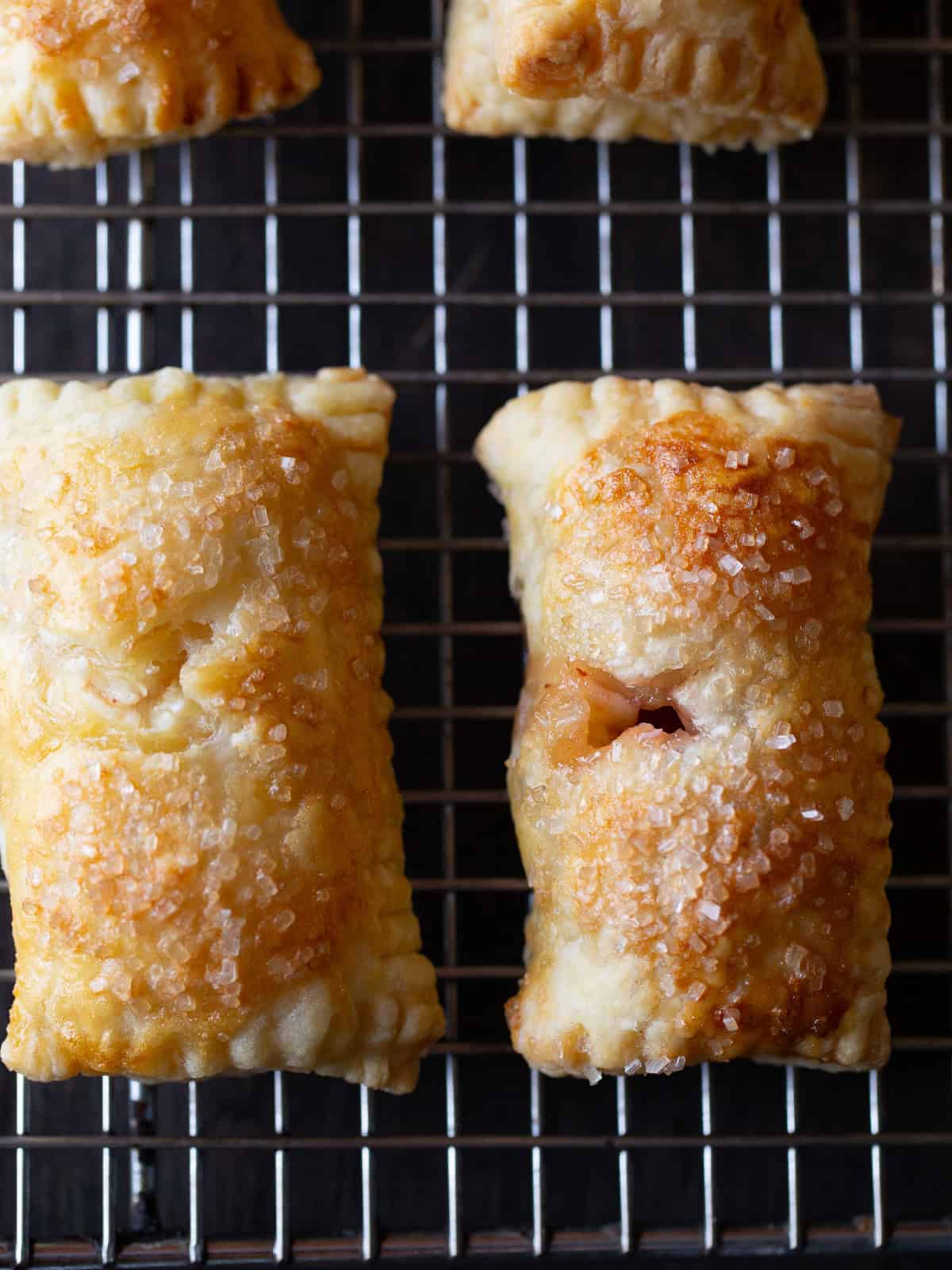 Cranberry cream cheese hand pies on a cooling rack.