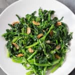 Sautéed Broccoli Rabe with garlic and red pepper flakes in a white bowl.