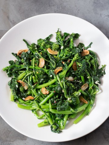 Sautéed Broccoli Rabe with garlic and red pepper flakes in a white bowl.