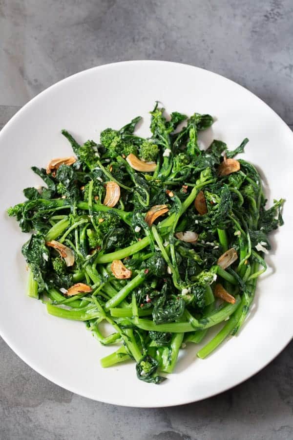 Sautéed Broccoli Rabe with garlic and red pepper flakes in a white bowl.