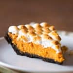 Pumpkin s'more pie slice on white plate.