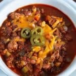 Bowl of Turkey Chili. Topped with shredded cheese and pickled jalapeños.