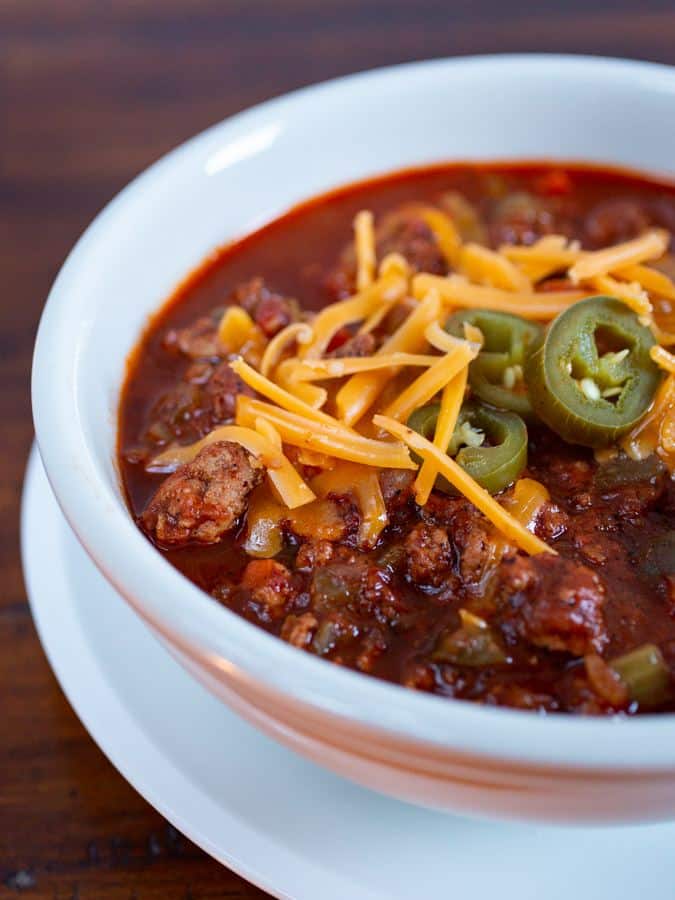 Bowl of Turkey Chili. Topped with shredded cheese and pickled jalapeños. 