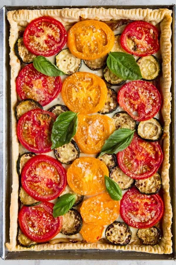 Baked tomato slab pie with basil.