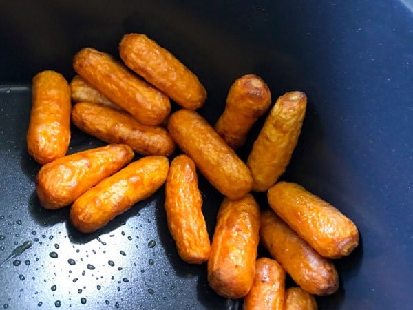 Baby carrots cooked in air fryer basket.
