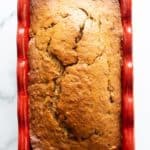 Brown sugar banana bread in red loaf pan.