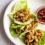 Chang's Chicken Lettuce Wraps on Plate with Bowl of Sambal Oelek.