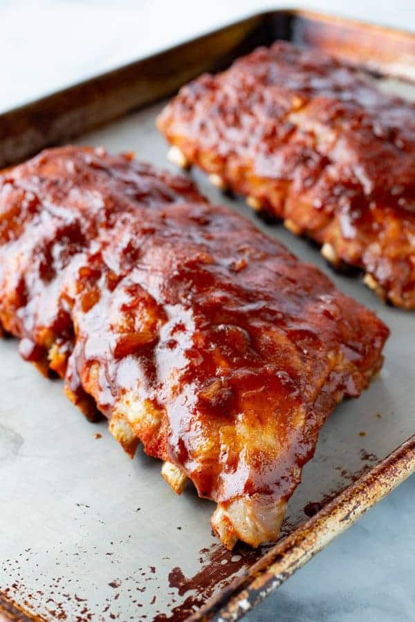 Cooked Instant Pot Ribs on a Sheet Pan. Brushed with BBQ sauce