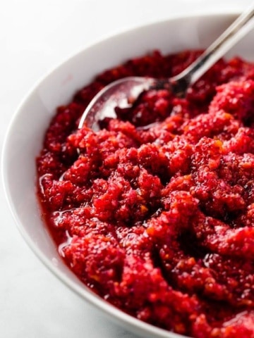Cranberry relish in a bowl with a spoon.