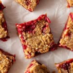 Baked cranberry oatmeal bar cut into squares.