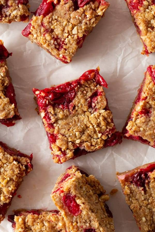 Baked cranberry oatmeal bar cut into squares.