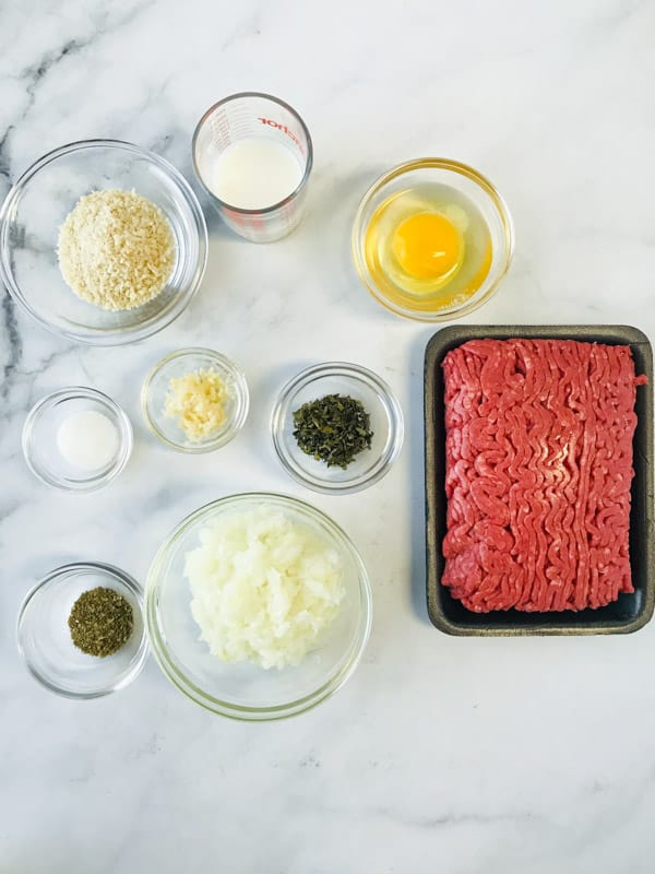 Ingredients for air fryer meatballs on a marble countertop.