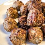 Air fryer meatballs on white plate.