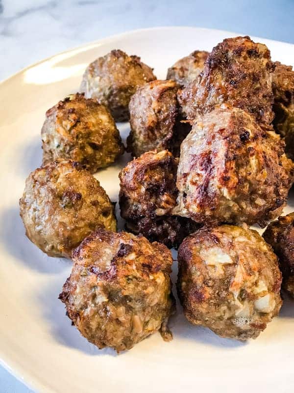 Air fryer meatballs on white plate.