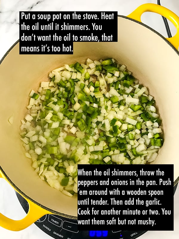 Raw onions and green peppers cooking in a pot.