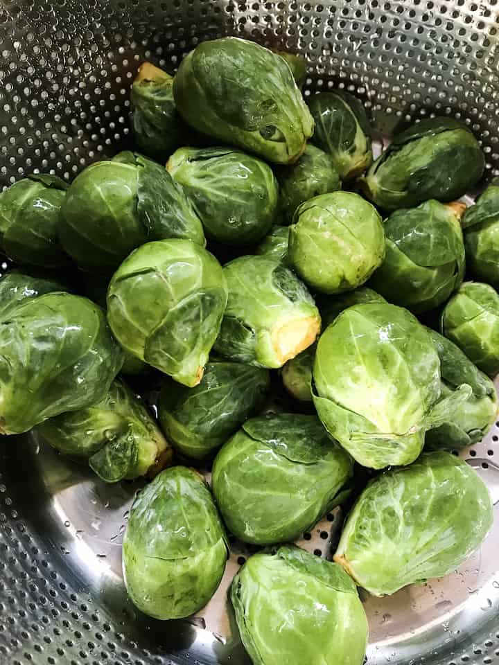 Washed Brussels sprouts in colander. 