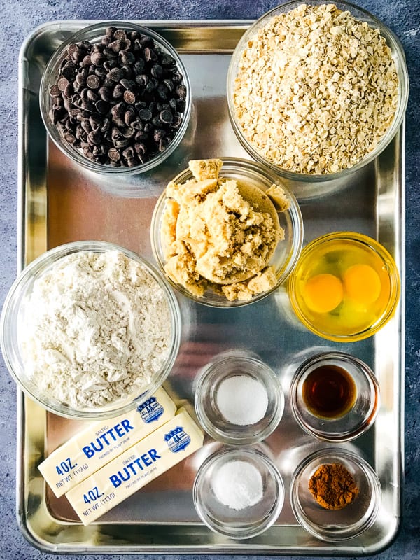 Ingredients for oatmeal chocolate chip bars on a sheet pan.