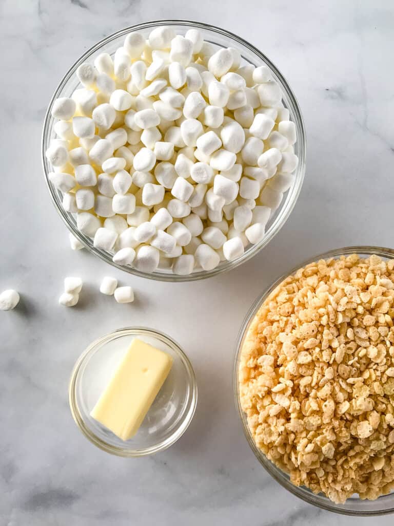 Ingredients for rice crispy treats in bowls on a counter.