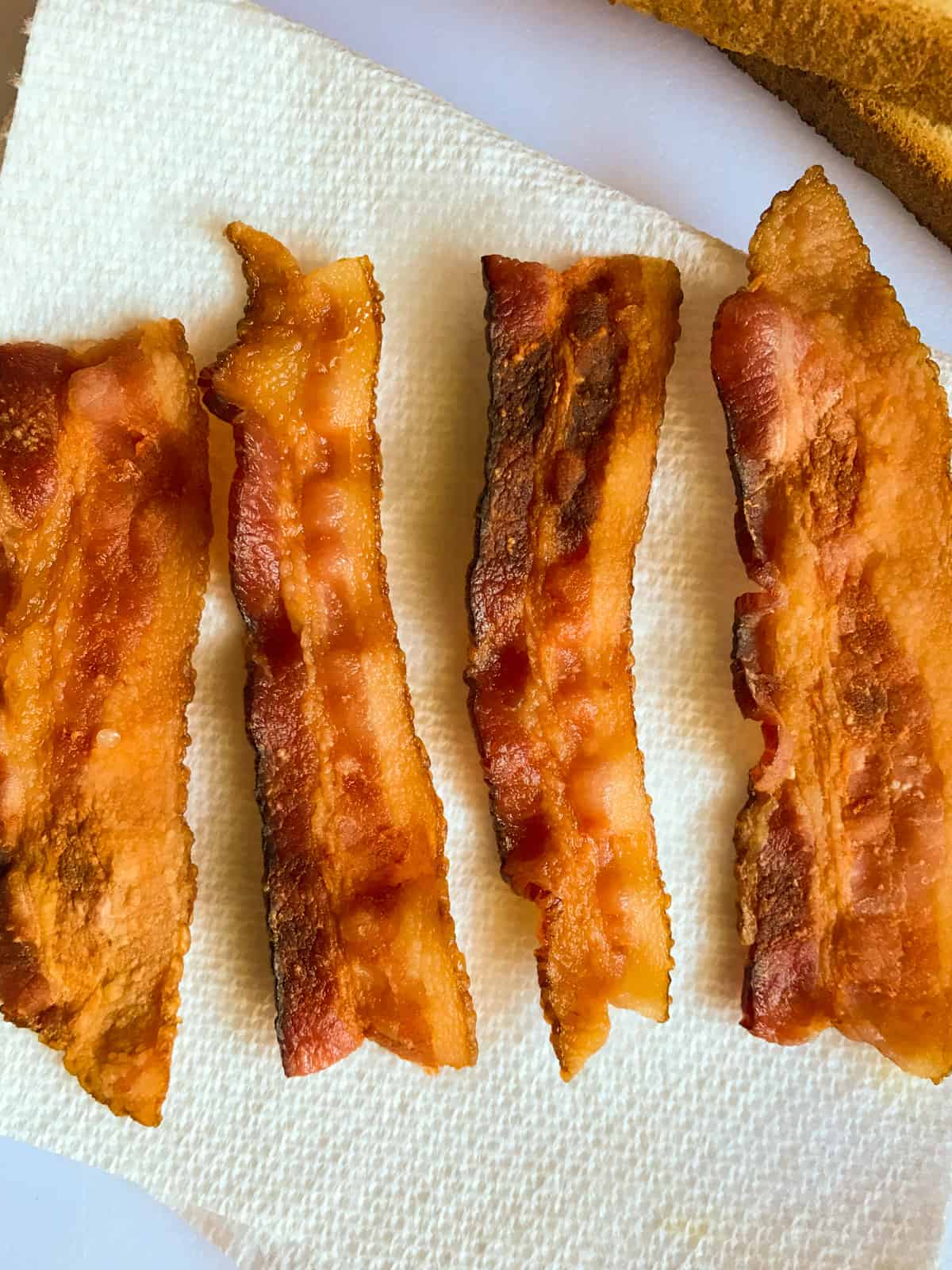 Cooked bacon, cut in half.
