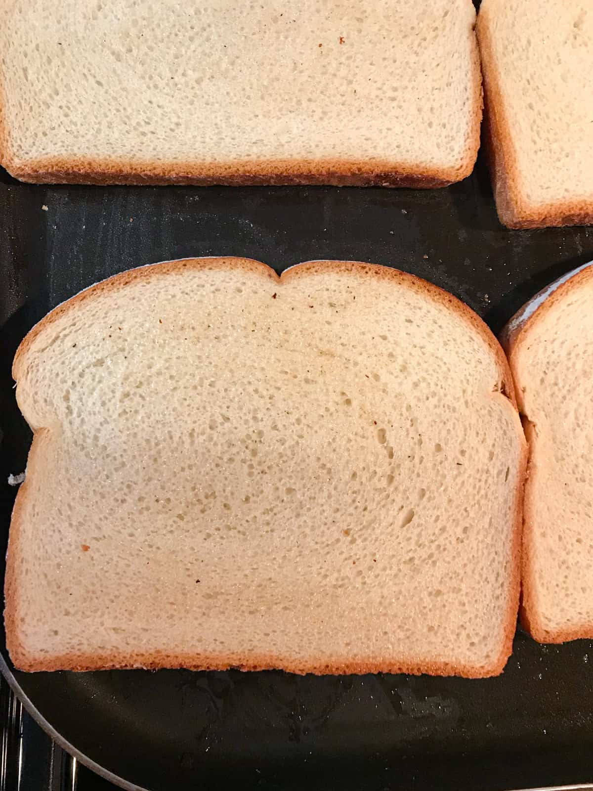 Slice of white bread on a griddle for BLT.