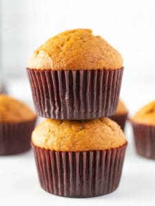 Two pumpkin muffins stacked on each other.