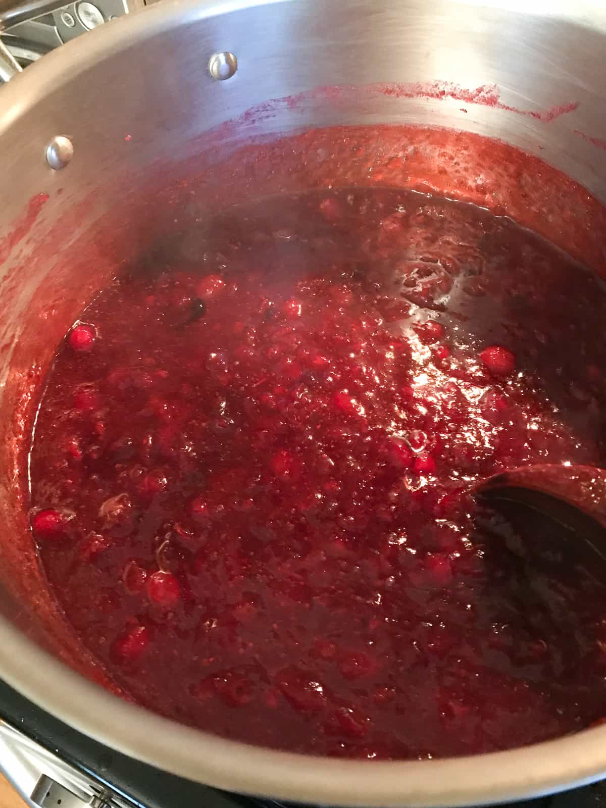 Cooked cranberry sauce in pot.