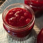 Cooked cranberry sauce in a canning jar.