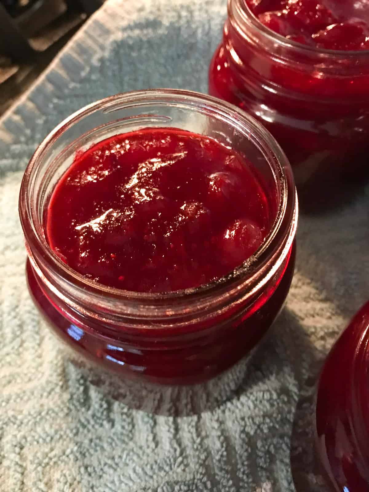 Cooked cranberry sauce in a canning jar.