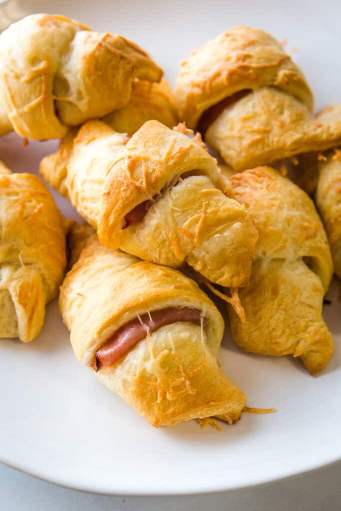 Ham and cheese crescent rolls on a plate.