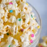 White chocolate coated popcorn with colored sprinkles.