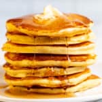 A Stack of Pancakes on a Plate with Syrup
