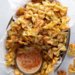 Plate of pasta chips with bowl of chipotle dip.