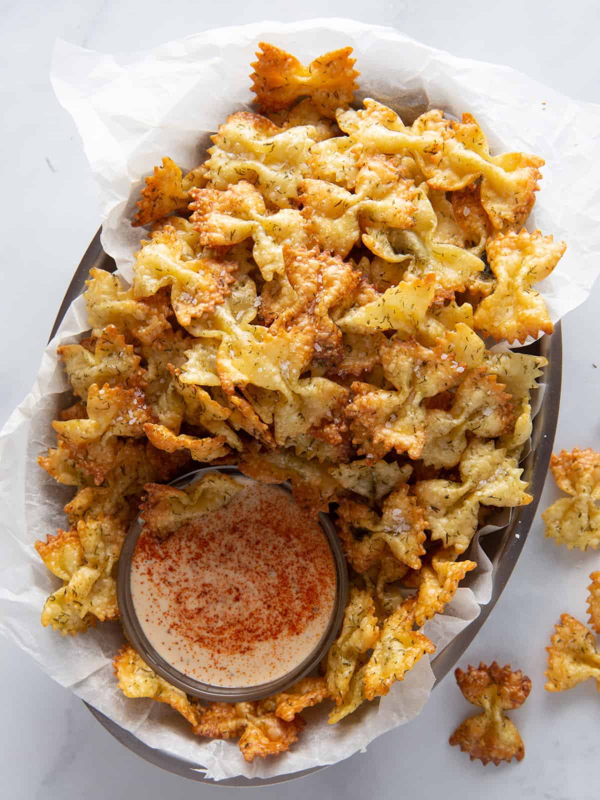 Plate of pasta chips with bowl of chipotle dip.