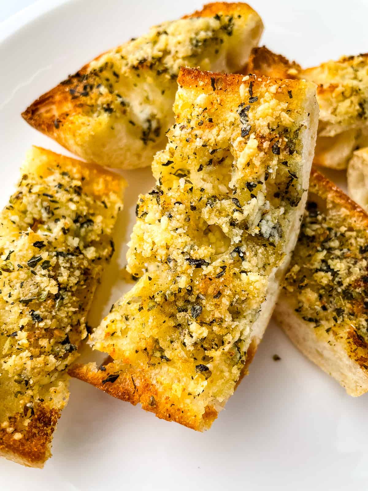 Slices of garlic bread on a plate.