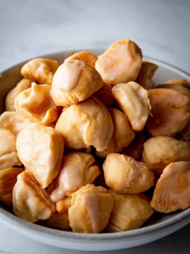 Bowl of baked and glazed honey butter biscuit bites.