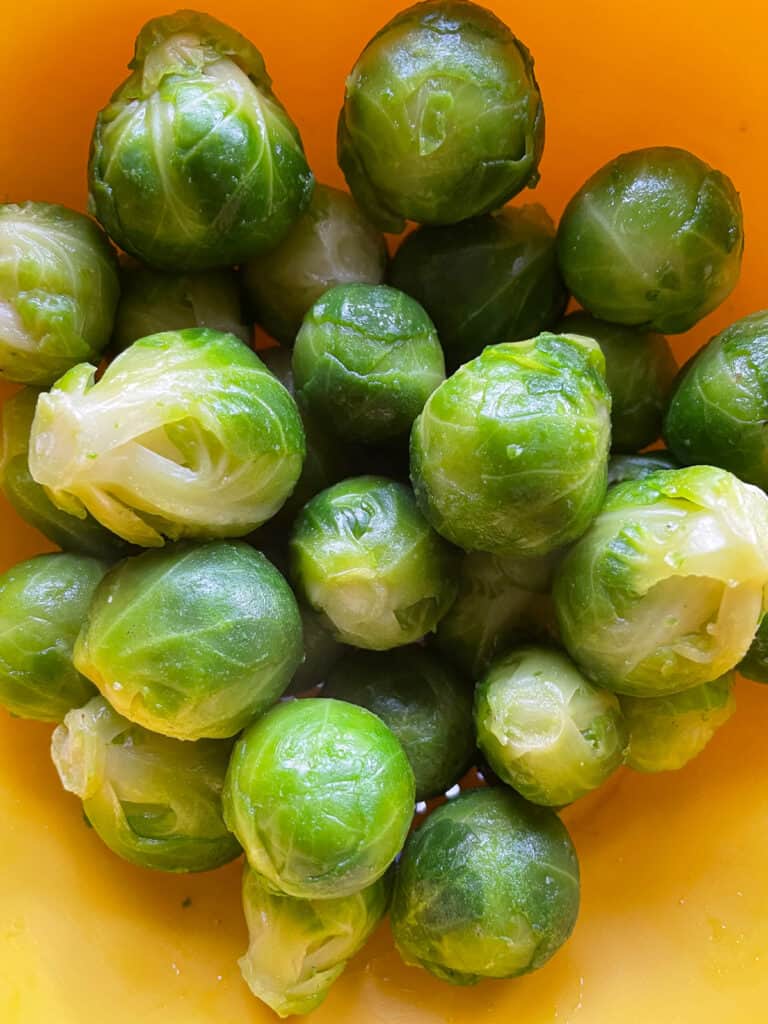 Thawed frozen Brussels sprouts in a colander. 