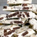 Oreo bark stacked on parchment paper.