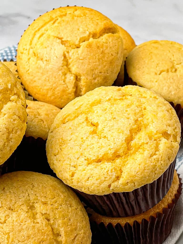 Baked corn muffins in a basket.