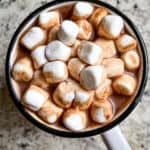 Mug of hot chocolate topped with marshmallows.