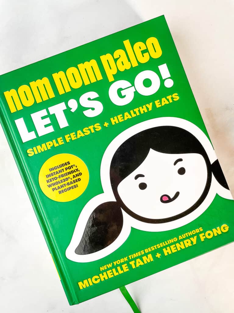 Nom Nom Paleo: Let's Go cookbook on a table.
