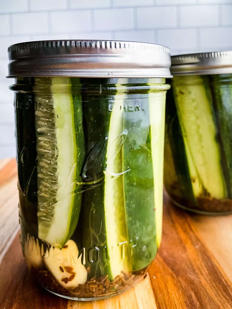 Refrigerator dill pickles in jar with lid.