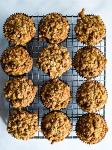 Zucchini crumb muffins on a cooling rack.